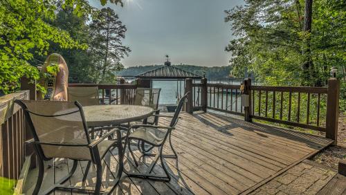 a wooden deck with a table and chairs and a gazebo at Lake Escape in Morganton