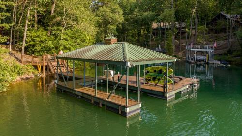a dock with a gazebo on a body of water at Lake Escape in Morganton