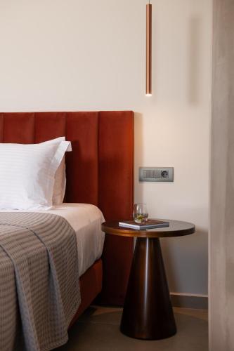 a hotel room with a bed and a table at Reveli Suites in Katelios