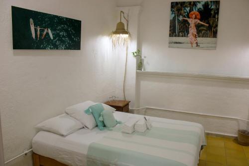 a bedroom with a bed with a stuffed animal on it at Sayulita Central Hotel in Sayulita