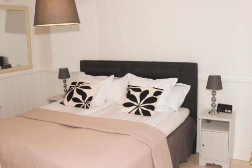 a bedroom with a large bed with two pillows at Near commuter train to Stockholm in Södertälje