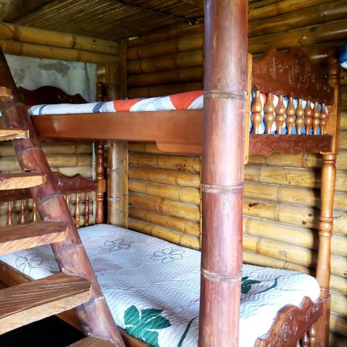 two bunk beds in a log cabin at Cabaña sol de oriente in Marinilla