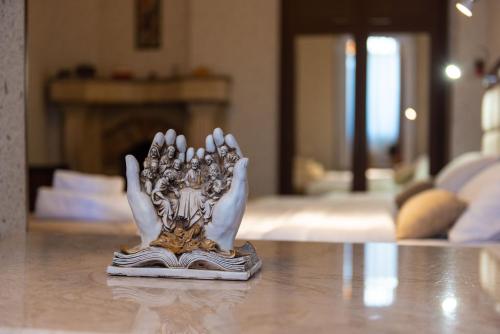 a silver statue sitting on top of a table at Kraveli Hotel in Tbilisi City