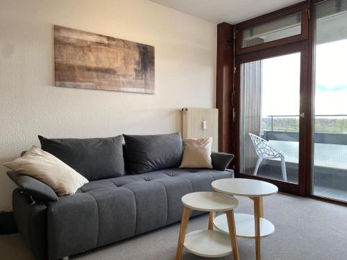 a living room with a couch and a table at Ferienwohnung Rheinblick in Kehl am Rhein