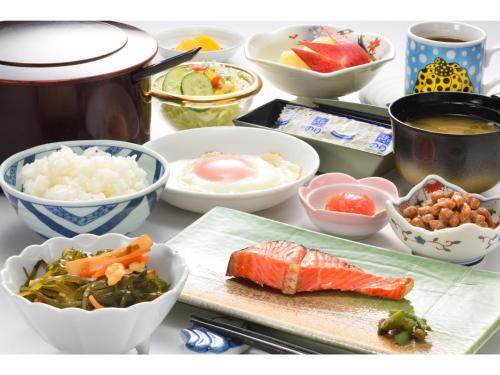 a table topped with bowls of food and vegetables at Towada City Hotel - Vacation STAY 47272v in Towada