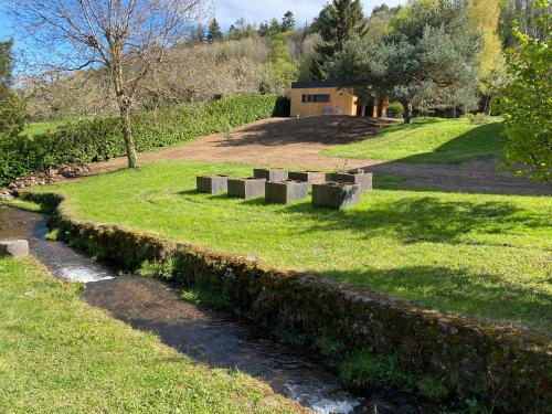 a garden with concrete blocks in the grass at L'Oustal Des Dômes in Orcines