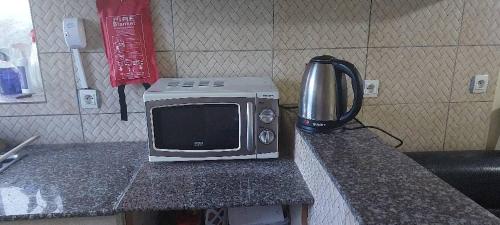 a microwave sitting on top of a counter at Home sweet home in Kigali
