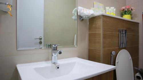 a bathroom with a sink and a mirror at Luxury 2BR Duplex Oasis in Masdar City - Stylish Retreat Near Masdar Park & City Centre in Abu Dhabi