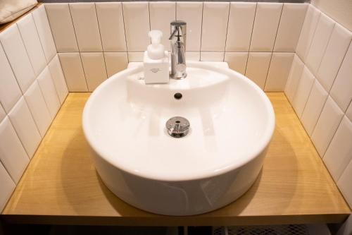 a white sink on a wooden counter in a bathroom at Tomoeyado - Vacation STAY 05898v in Shimada