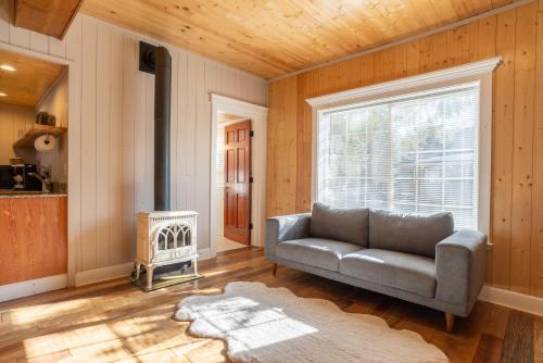 a living room with a couch and a window at Shasta View Lodge in McCloud