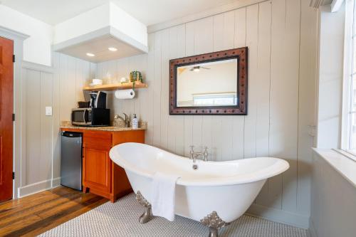a bath tub in a bathroom with a mirror at Shasta View Lodge in McCloud