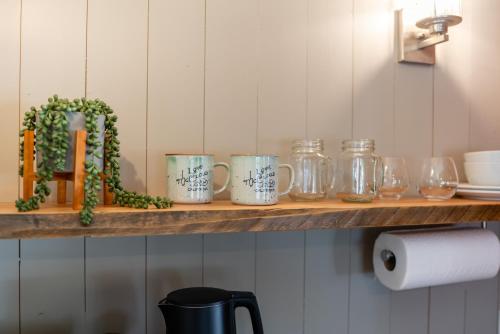 a shelf with mason jars and glasses on it at Shasta View Lodge in McCloud