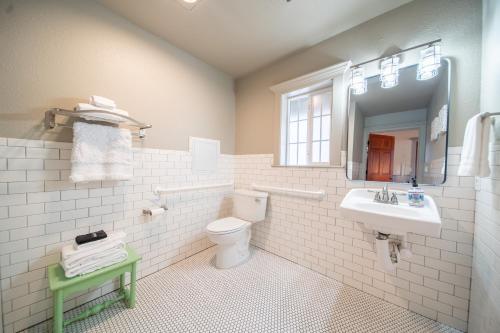 a bathroom with a toilet and a sink and a mirror at Shasta View Lodge in McCloud