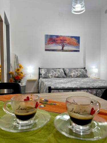 two cups of coffee on a table in a living room at La Casuzza del Borgo in Agrigento
