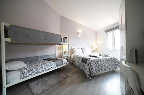 a bedroom with a bed and a bunk bed at Guest House Triunfo in Porto