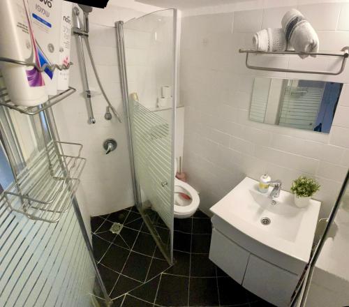a bathroom with a shower and a toilet and a sink at מלון בירת החומות• The Walled Capital Hotel in Jerusalem