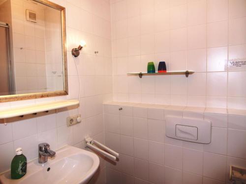 a white bathroom with a sink and a mirror at Apartments Blue House, Putbus in Putbus