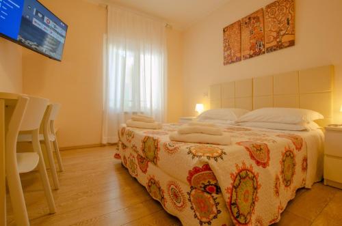 a bedroom with a large bed with towels on it at Hotel Del Buono Wellness & Medical Spa in Chianciano Terme