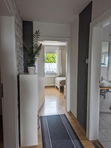 a hallway with a living room with a plant on top at FeWo Am Lewerberg in Liebenburg