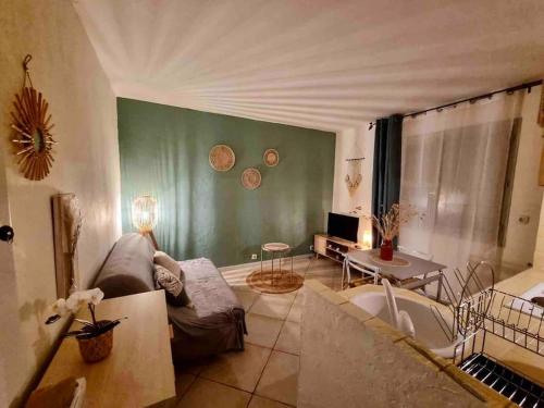 a living room with a couch and a table at Le Studio Cosy *Place du village in Les Salles-sur-Verdon