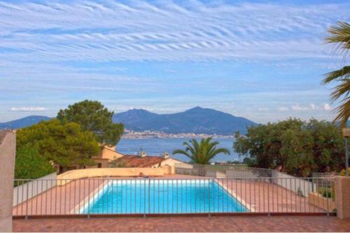 einen Pool mit Blick auf das Wasser in der Unterkunft Appartement vue Mer à Porticcio in Porticcio