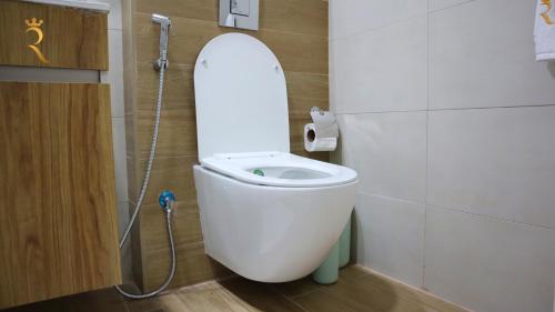 a bathroom with a toilet with the lid up at Duplex Elegance Retreat Transit - 2 BR in Abu Dhabi