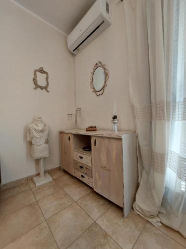 a bathroom with a sink and a dresser at Antique Apartment in Afitos