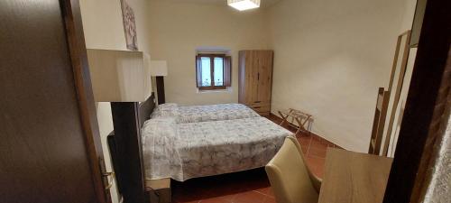 a small room with a bed and a window at Casa Badia in Radda in Chianti