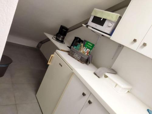 a kitchen with a counter with a coffee maker on it at Cozy apartment near to the airport in Kouvarás