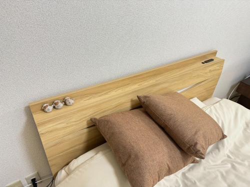 名古屋的住宿－Rainbow takakura - Vacation STAY 16466，一张带两个枕头的床的木制床头板