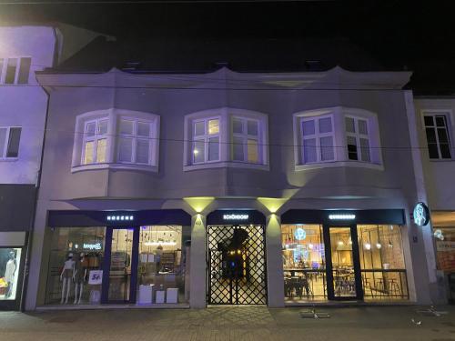 a store front of a building at night at Schöndorf Hostel - virtual reception in Bratislava