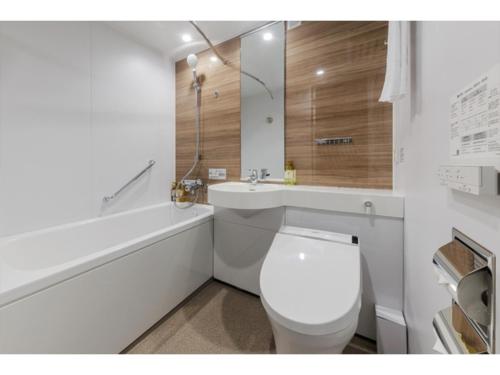 a bathroom with a toilet and a sink and a tub at Soma Station Hotel - Vacation STAY 40250v in Soma