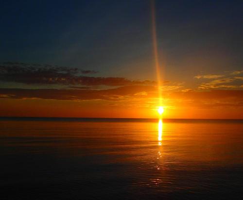 a sunset over the ocean with the sun in the sky at Margarita del Sol Hotel Costa Maya in Mahahual