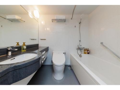 a bathroom with a sink and a toilet and a tub at Soma Station Hotel - Vacation STAY 40262v in Soma