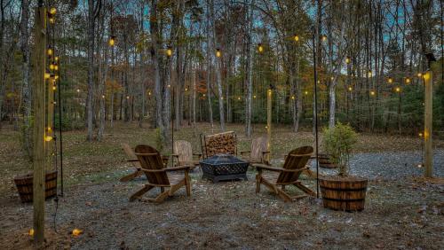 a group of chairs and a table and a fire pit at Meadow Creek Retreat in Cherry Log