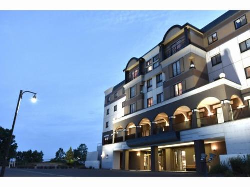 a large building with a street light in front of it at Furano Hops Hotel - Vacation STAY 41818v in Kami-furano