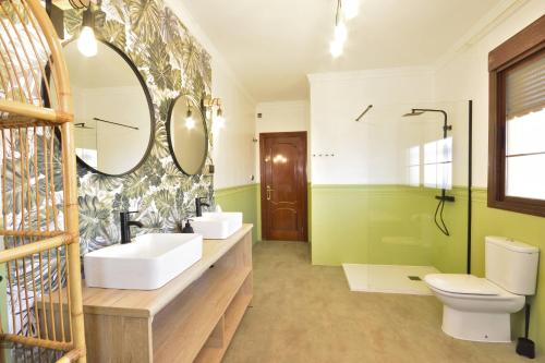 a bathroom with two sinks and a mirror at The Castle on the Hill! in Málaga
