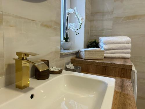 a bathroom with a white tub and a sink at LEO Apartment FREE PARKING - President Palace in Bratislava