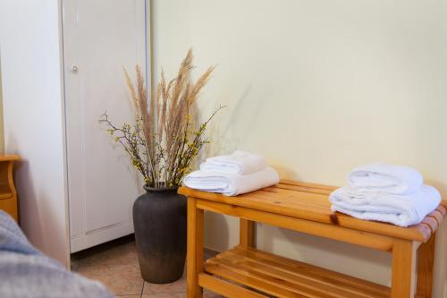 a table with towels on it with a vase at Almyra Apartments & Studios in Agios Gordios
