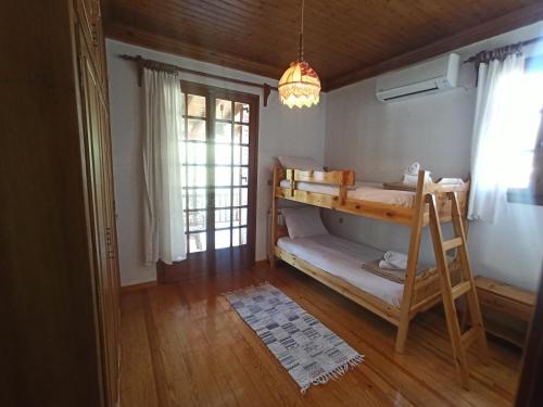 a bedroom with a bunk bed and a ladder at Seaside Selana Home in Nikiana