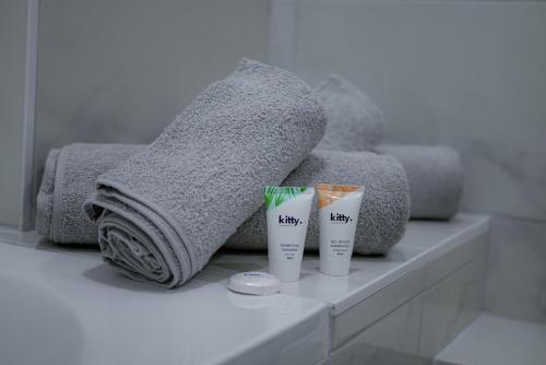 une salle de bain avec deux tasses sur un comptoir avec des serviettes dans l'établissement Le Bazacle - Sublime Logement en Hypercentre, à Toulouse