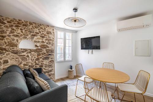 a living room with a couch and a table at Cozy renovated 1 bedroom Suquet Cannes Center - 1BR in Cannes