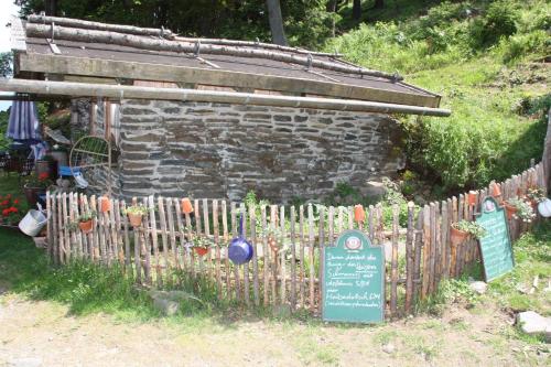 a fence with a sign in front of a garden at Schönblick Hohenbogen in Neukirchen beim Heiligen Blut