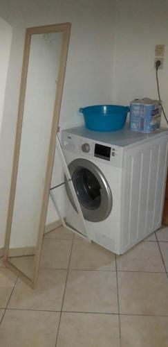 a washing machine with a bowl on top of it at Biky's room's in Moudhros