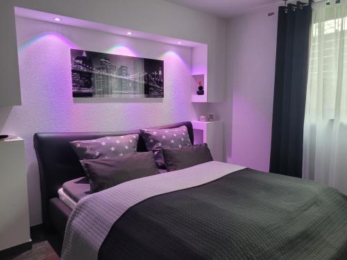 a purple bedroom with a bed with purple lighting at Luxury Appartement Marz-Europapark, Rulantika in Mahlberg