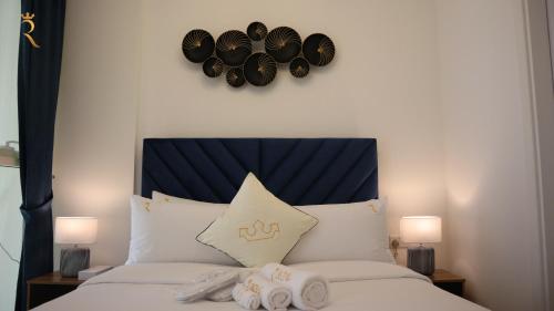 a bedroom with a bed with hats on the wall at Stylish 2BR Duplex - Chic Masdar Modern Stay in Abu Dhabi