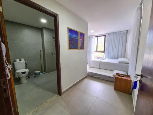 a bathroom with a shower and a toilet and a tub at Porto de Galinhas PORTO EXCLUSIVE BY AFT in Porto De Galinhas
