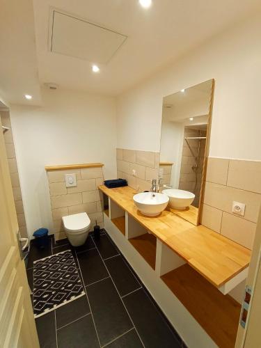 a bathroom with two sinks and a mirror at Studio de charme avec vue, en plein coeur de Florac in Florac Trois Riviere