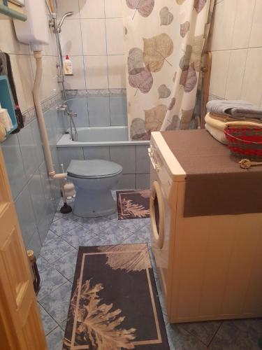 a bathroom with a toilet and a tub and a sink at Apartman in Sarajevo