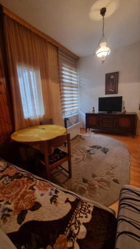 a living room with a table and a couch at Apartman in Sarajevo